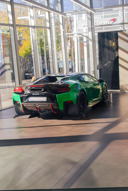 Green Lamborghini Temerario on display inside a bright glass-fronted showroom